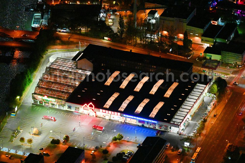 Aerial image at night Berlin - Night lighting Building of the construction market Bauhaus Schnellerstrasse - federal road B96a - Karlshorster Strasse in the district Treptow in Berlin