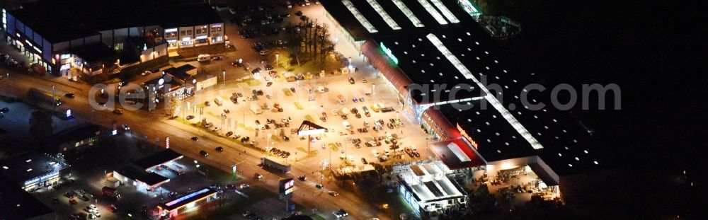 Lübeck at night from the bird perspective: Night view building of the construction market of hagebaumarkt in Luebeck in the state Schleswig-Holstein