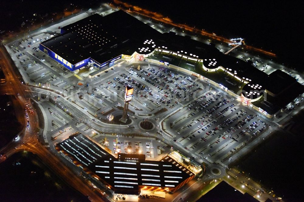 Lübeck at night from above - Night view building of the store - furniture market IKEA der IKEA Deutschland GmbH & Co. KG in Luebeck in the state Schleswig-Holstein. On the ground as well a HORNBACH building supplies store and the LUVSHOPPING shopping centre