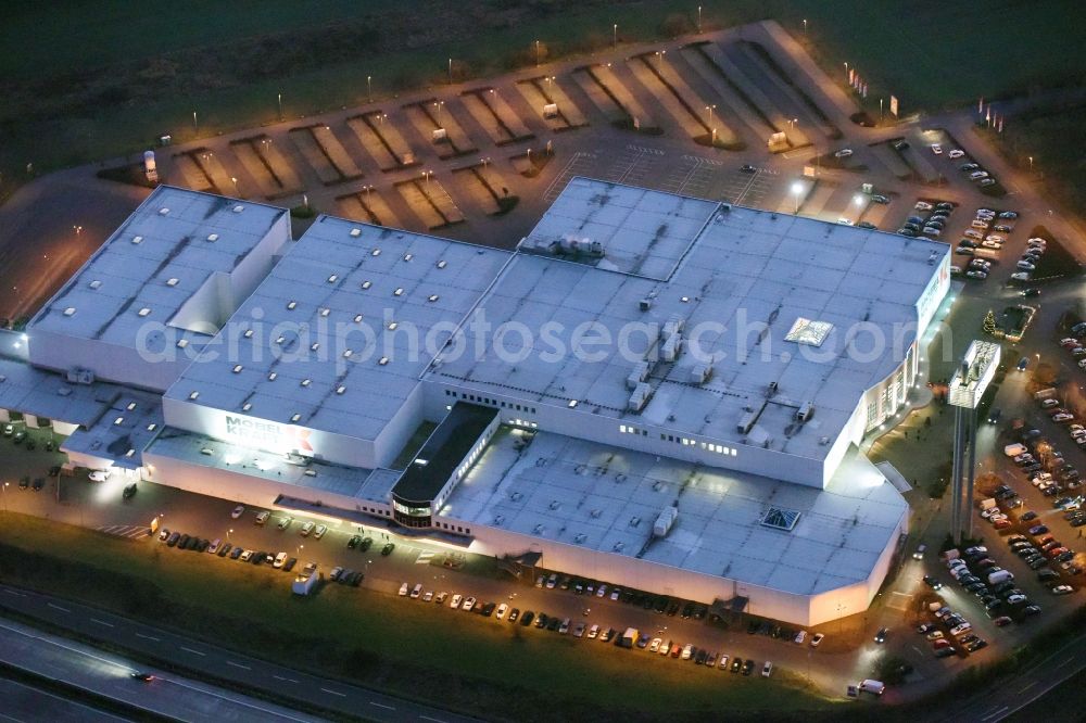 Fredersdorf-Vogelsdorf at night from the bird perspective: Night view building of the store - furniture market Moebel Kraft GmbH & Co. KG in Fredersdorf-Vogelsdorf in the state Brandenburg