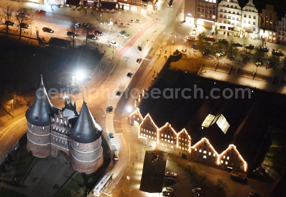 Aerial photograph at night Lübeck - Night view holsten Gate in the city center of the old town - center of Luebeck in Schleswig-Holstein