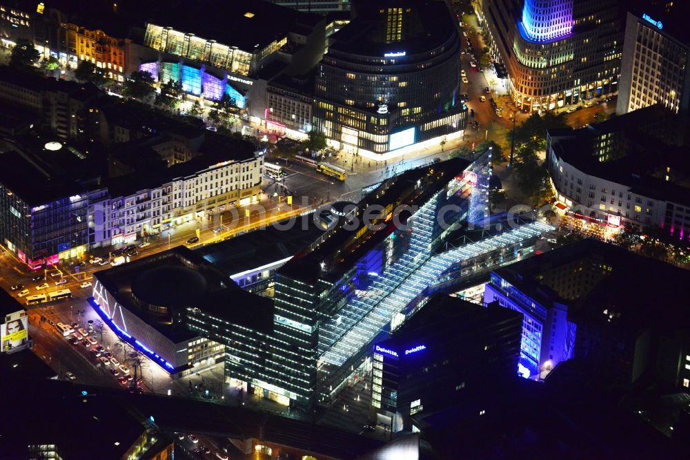 Berlin at night from the bird perspective: Night aerial view of the illuminated Kranzler Eck building at the intersection between Joachimstalerstrasse and Kurfürstendamm in Berlin Charlottenburg. The imposing light installations are part of the annual Festival of Lights event