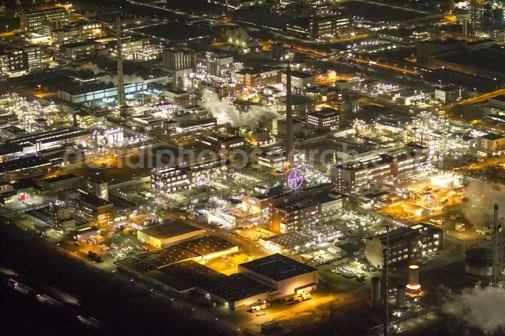 Dormagen at night from the bird perspective: Night aerial view of industrial site Chempark (formerly Bayer Dormagen or Dormagen site) in Dormagen, in North Rhine-Westphalia