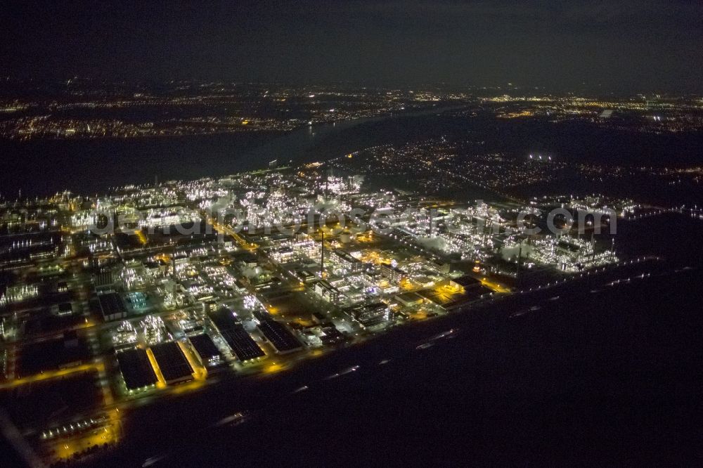 Dormagen at night from the bird perspective: Night aerial view of industrial site Chempark (formerly Bayer Dormagen or Dormagen site) in Dormagen, in North Rhine-Westphalia