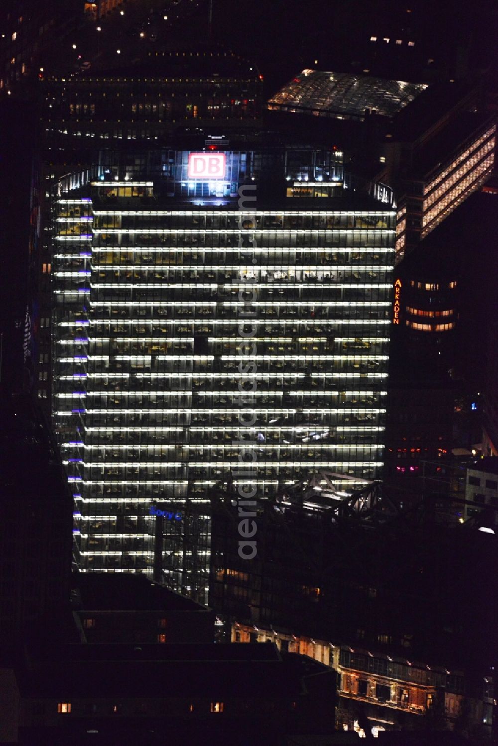 Aerial photograph at night Berlin - Night aerial view from the night illuminated skyscraper German-Bahn Tower - Sony Center am Potsdamer Platz in Berlin Mitte