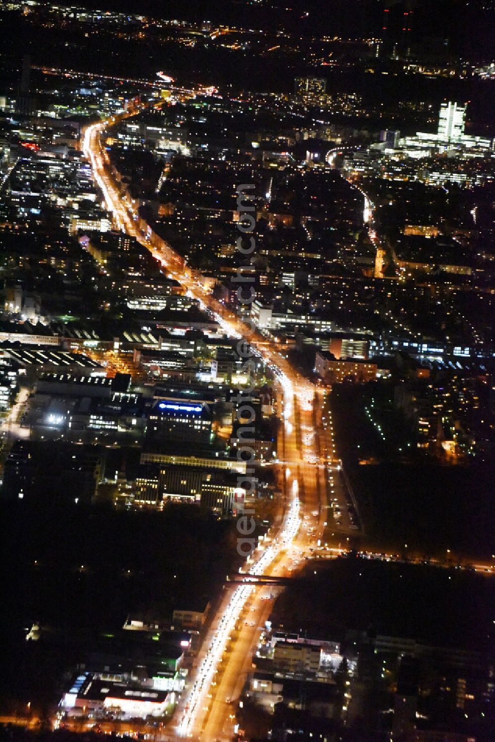 München at night from above - Night aerial view from Milbertshofen district with the illuminated road along the Triebstrasse, Moosacherstrasse street and the Frankfurter Ring in Munich in the state Bavaria