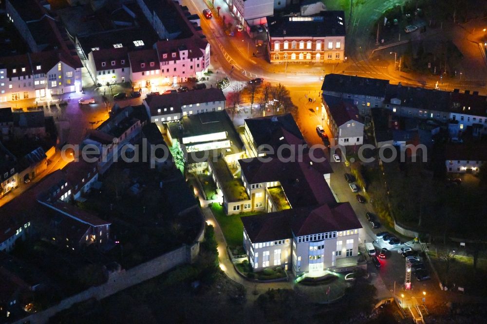 Aerial photograph at night Strausberg - Night lighting Banking administration building of the financial services company Sparkasse on Karl-Liebknecht-Strasse coner Grosse Strasse in Strausberg in the state Brandenburg, Germany