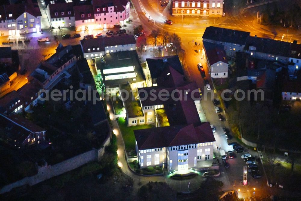 Aerial image at night Strausberg - Night lighting Banking administration building of the financial services company Sparkasse on Karl-Liebknecht-Strasse coner Grosse Strasse in Strausberg in the state Brandenburg, Germany