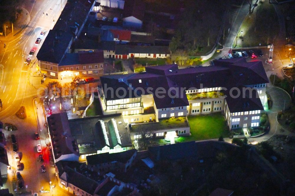 Aerial photograph at night Strausberg - Night lighting Banking administration building of the financial services company Sparkasse on Karl-Liebknecht-Strasse coner Grosse Strasse in Strausberg in the state Brandenburg, Germany