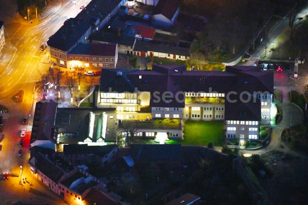 Aerial image at night Strausberg - Night lighting Banking administration building of the financial services company Sparkasse on Karl-Liebknecht-Strasse coner Grosse Strasse in Strausberg in the state Brandenburg, Germany