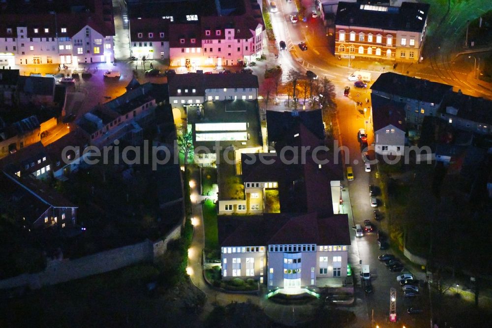 Aerial photograph at night Strausberg - Night lighting Banking administration building of the financial services company Sparkasse on Karl-Liebknecht-Strasse coner Grosse Strasse in Strausberg in the state Brandenburg, Germany