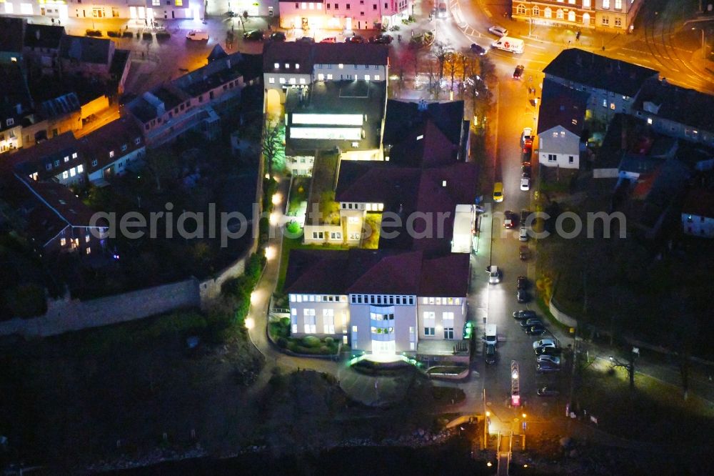 Strausberg at night from above - Night lighting Banking administration building of the financial services company Sparkasse on Karl-Liebknecht-Strasse coner Grosse Strasse in Strausberg in the state Brandenburg, Germany