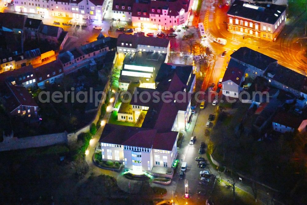 Aerial photograph at night Strausberg - Night lighting Banking administration building of the financial services company Sparkasse on Karl-Liebknecht-Strasse coner Grosse Strasse in Strausberg in the state Brandenburg, Germany