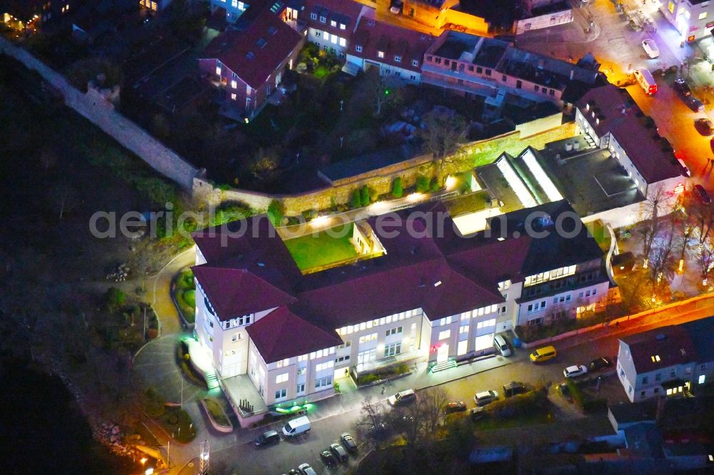 Aerial image at night Strausberg - Night lighting Banking administration building of the financial services company Sparkasse on Karl-Liebknecht-Strasse coner Grosse Strasse in Strausberg in the state Brandenburg, Germany