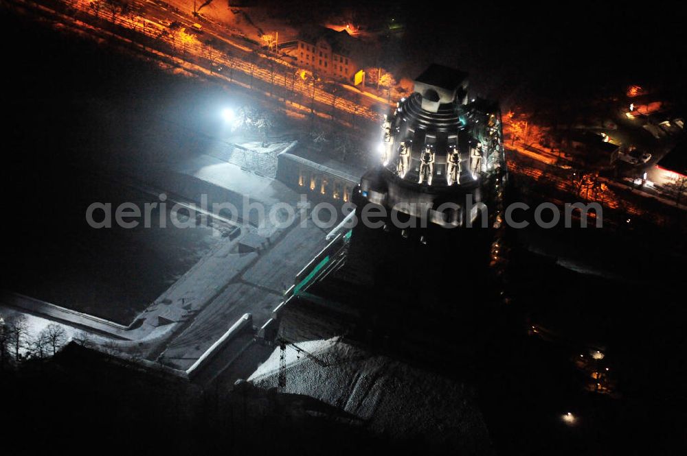 Leipzig at night from the bird perspective: Nachtluftbild vom Völkerschlachtdenkmal - winterlich mit Schnee bedeckt. Night aerial view of the Battle Monument Leipzig.