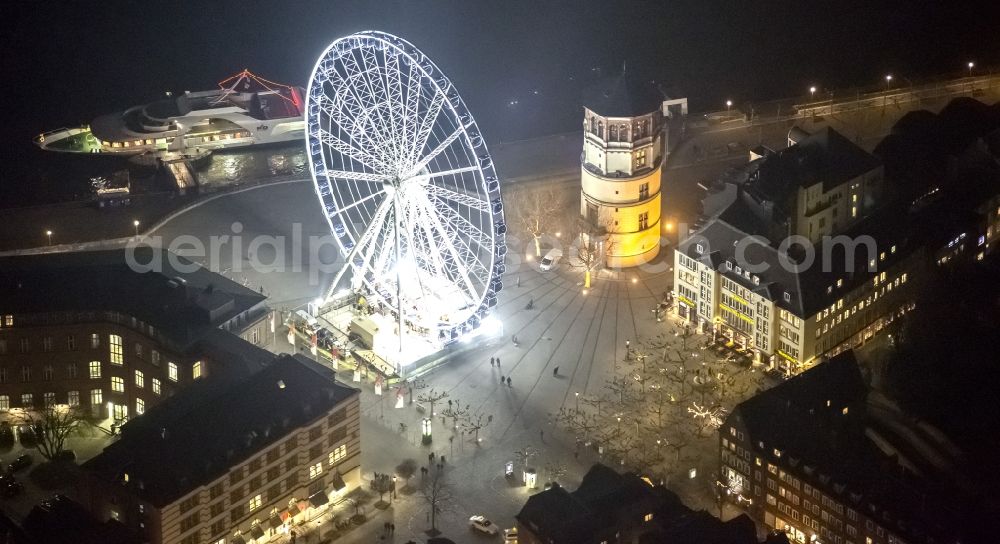 Aerial photograph at night Düsseldorf - Night aerial view of the Christmas Market Ferris wheel on the castle square at the castle tower in Dusseldorf in North Rhine-Westphalia