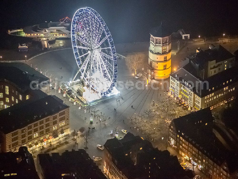 Aerial image at night Düsseldorf - Night aerial view of the Christmas Market Ferris wheel on the castle square at the castle tower in Dusseldorf in North Rhine-Westphalia