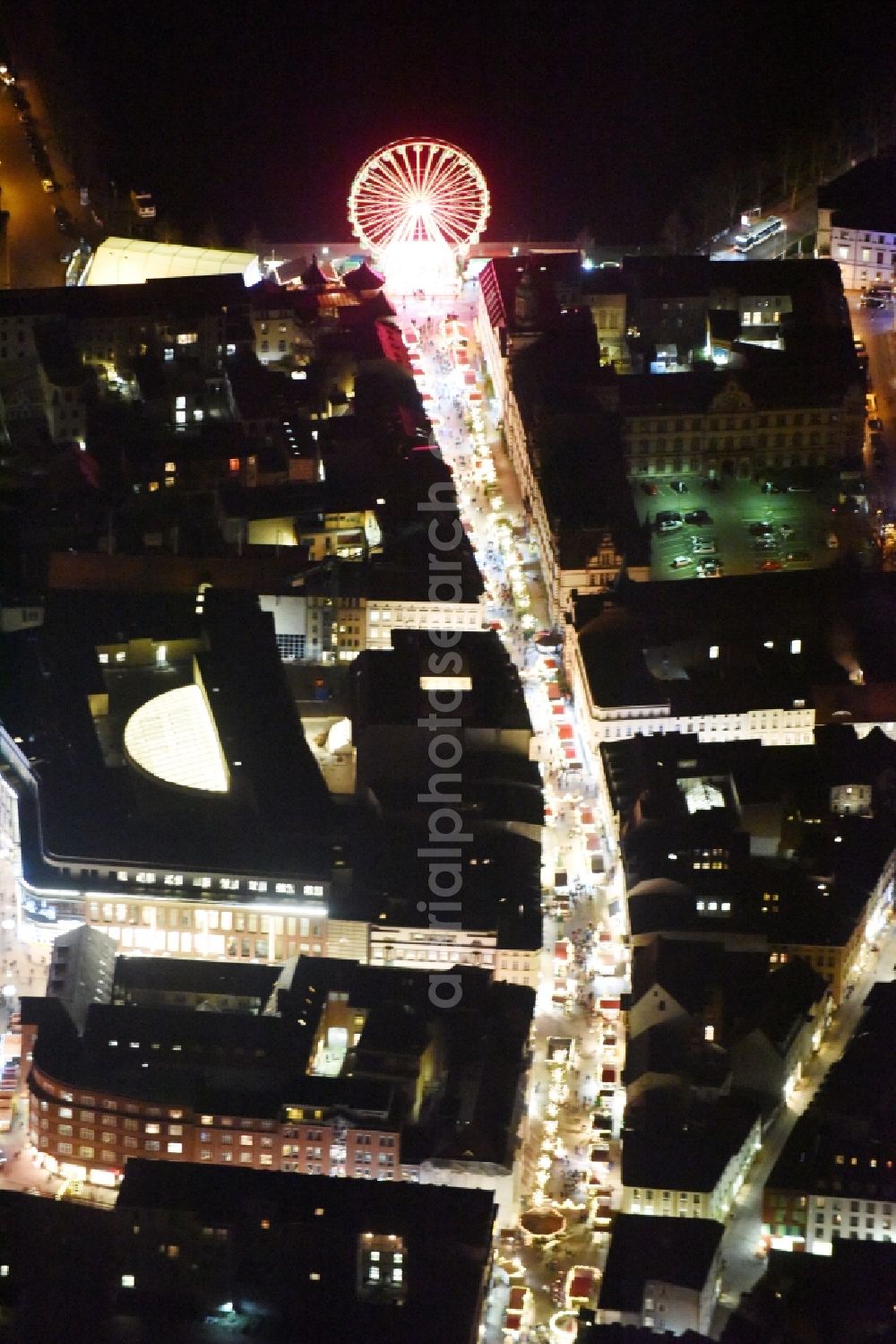 Aerial image at night Schwerin - Night view of the christmassy market event grounds and sale huts and booths along the Mecklenburgstrasse in Schwerin in the state Mecklenburg - Western Pomerania