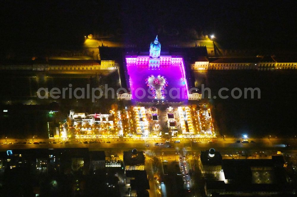 Aerial image at night Berlin - Night view of christmassy market event grounds and sale huts and booths am Schloss Charlotteburg in the district Bezirk Charlottenburg-Wilmersdorf in Berlin