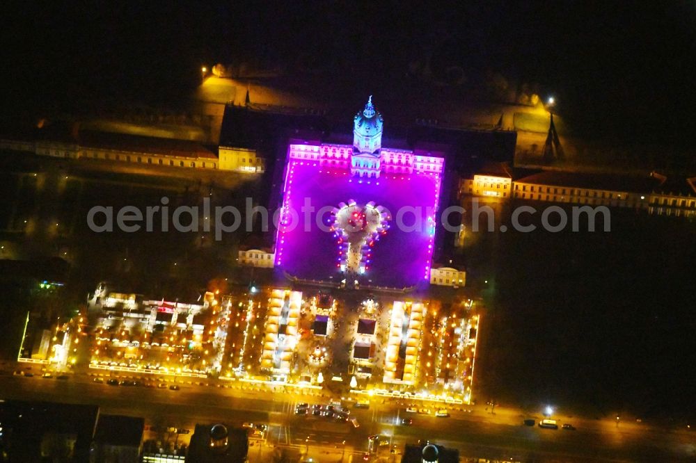 Berlin at night from above - Night view of christmassy market event grounds and sale huts and booths am Schloss Charlotteburg in the district Bezirk Charlottenburg-Wilmersdorf in Berlin