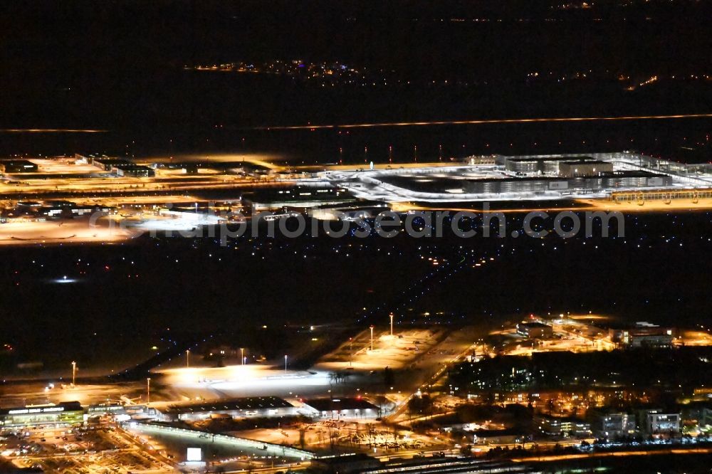 Schönefeld at night from above - Night image of wintry snowy area and main building of the airport Berlin-Schoenefeld SXF in Schoenefeld in the state of Brandenburg