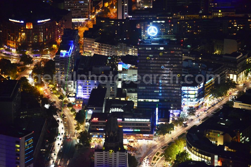 Berlin at night from the bird perspective: Night aerial view of illuminated buildings in the City West during the Festival of Light in Berlin Charlottenburg. The impressive installations of the annual event immerse the commercial and residential space along the Kurfuerstendamm in colorful lights. Part of the attractions are among others the Neues Kranzler Eck and the Breitscheidplatz