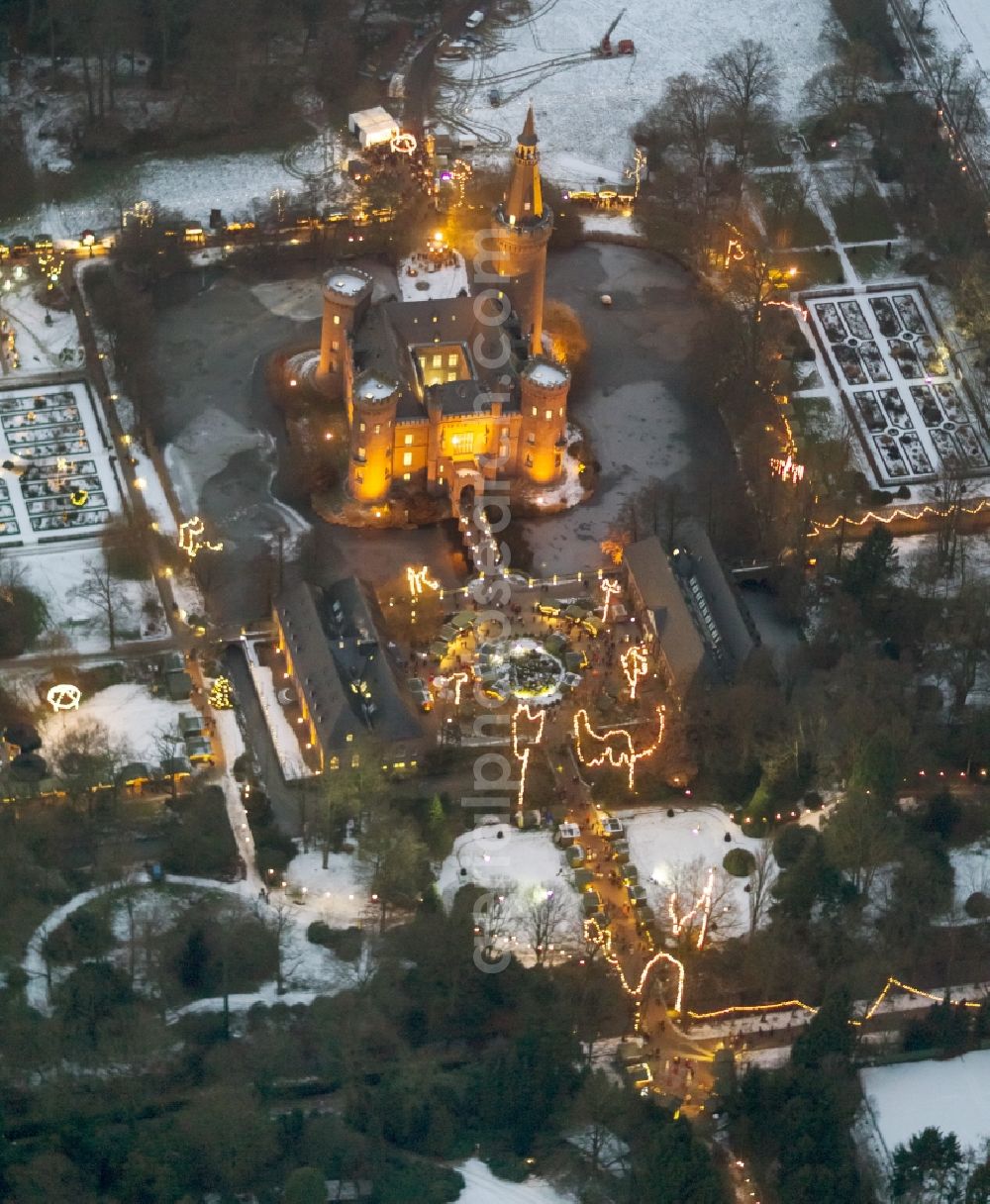 Aerial image at night Bedburg-Hau - Night lighting building and castle park systems of water castle Moyland in the district Till-Moyland in Bedburg-Hau in the state North Rhine-Westphalia, Germany