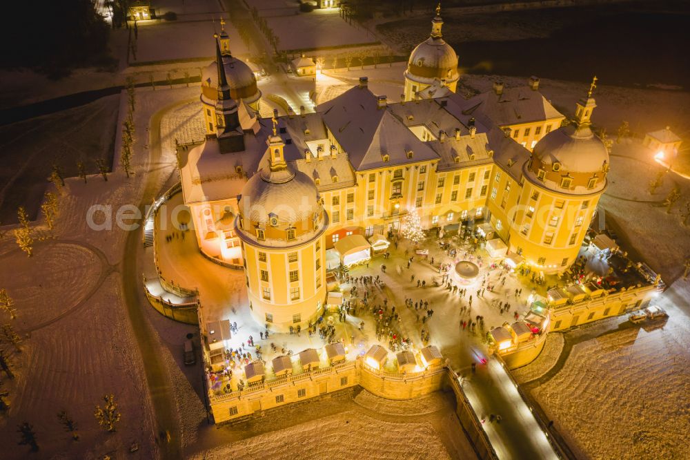 Aerial photograph at night Moritzburg - Night lights and illumination Christmas market at the hunting and moated castle in the castle pond in Moritzburg in the federal state of Saxony, Germany