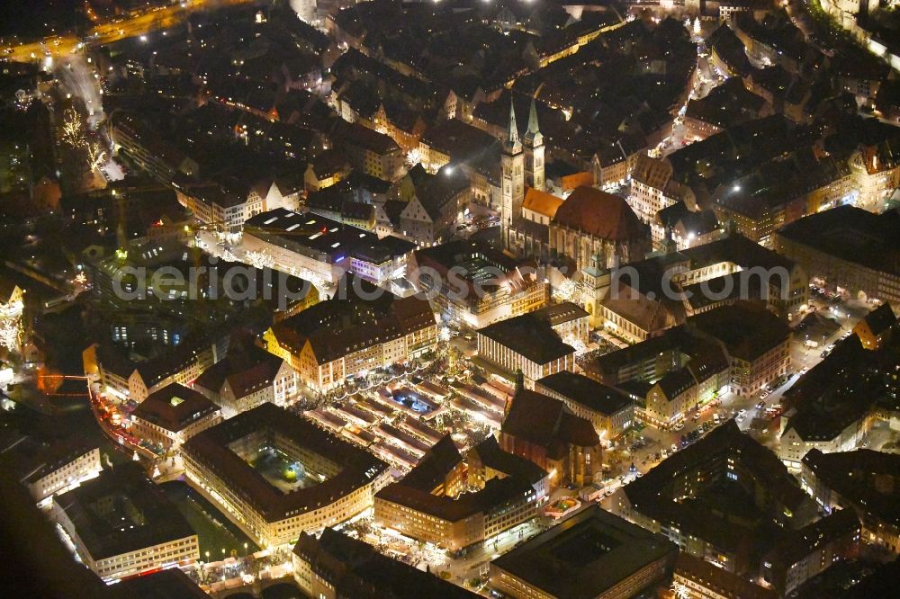 Aerial photograph at night Nürnberg - Night lighting Christmassy market event grounds and sale huts and booths on Platz of Nuernberger Hauptmarkt in Nuremberg in the state Bavaria, Germany