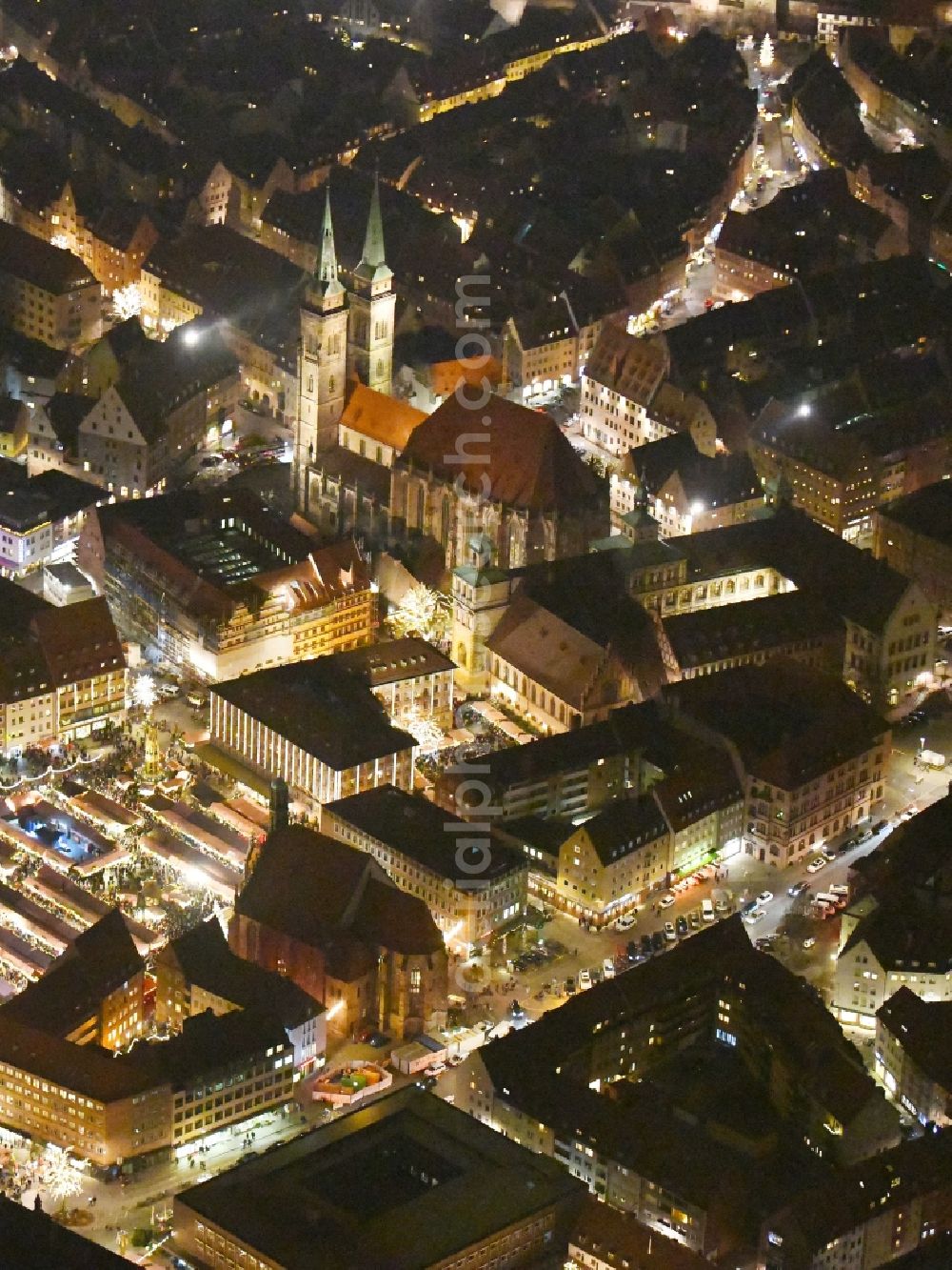 Aerial image at night Nürnberg - Night lighting Christmassy market event grounds and sale huts and booths on Platz of Nuernberger Hauptmarkt in Nuremberg in the state Bavaria, Germany