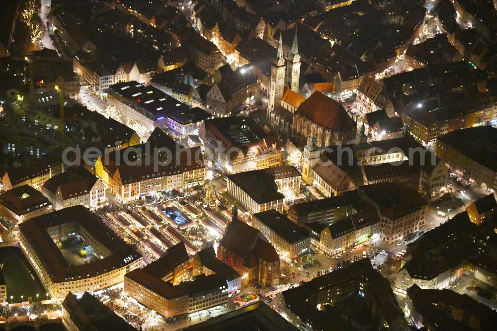 Aerial image at night Nürnberg - Night lighting Christmassy market event grounds and sale huts and booths on Platz of Nuernberger Hauptmarkt in Nuremberg in the state Bavaria, Germany