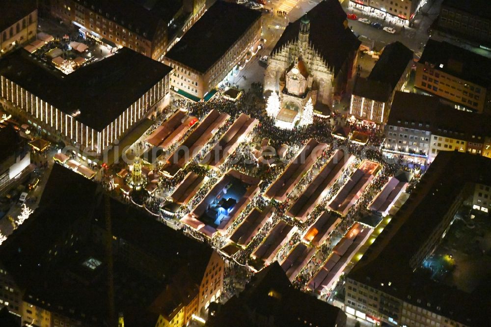 Nürnberg at night from above - Night lighting Christmassy market event grounds and sale huts and booths on Platz of Nuernberger Hauptmarkt in Nuremberg in the state Bavaria, Germany