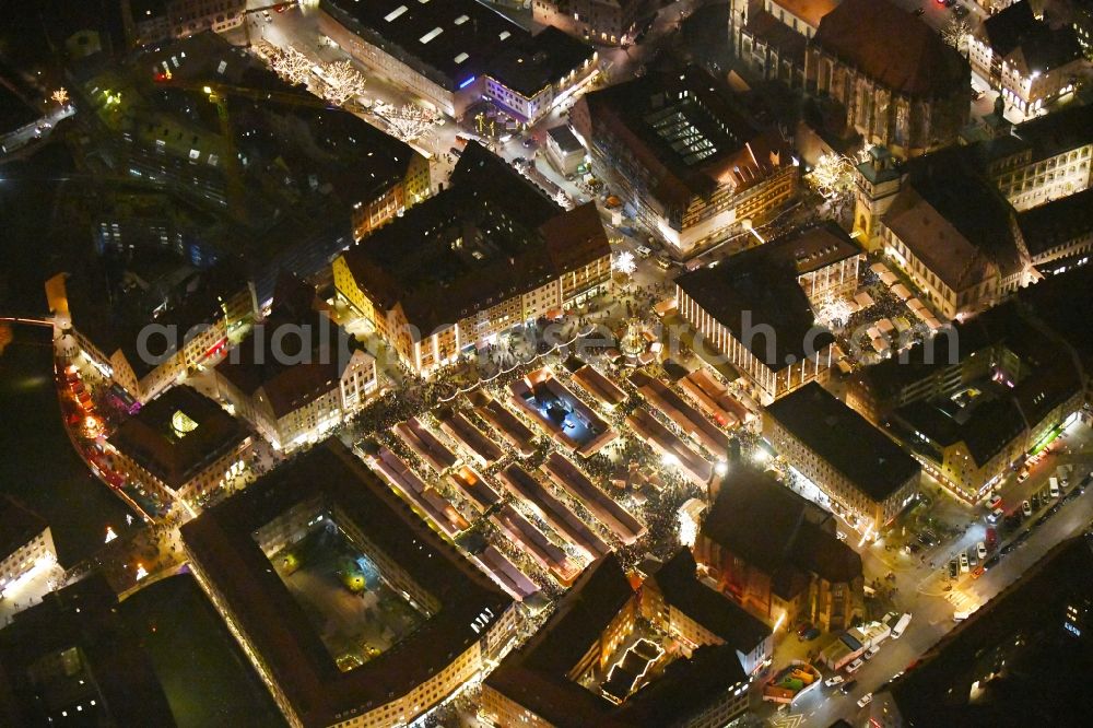 Aerial photograph at night Nürnberg - Night lighting Christmassy market event grounds and sale huts and booths on Platz of Nuernberger Hauptmarkt in Nuremberg in the state Bavaria, Germany