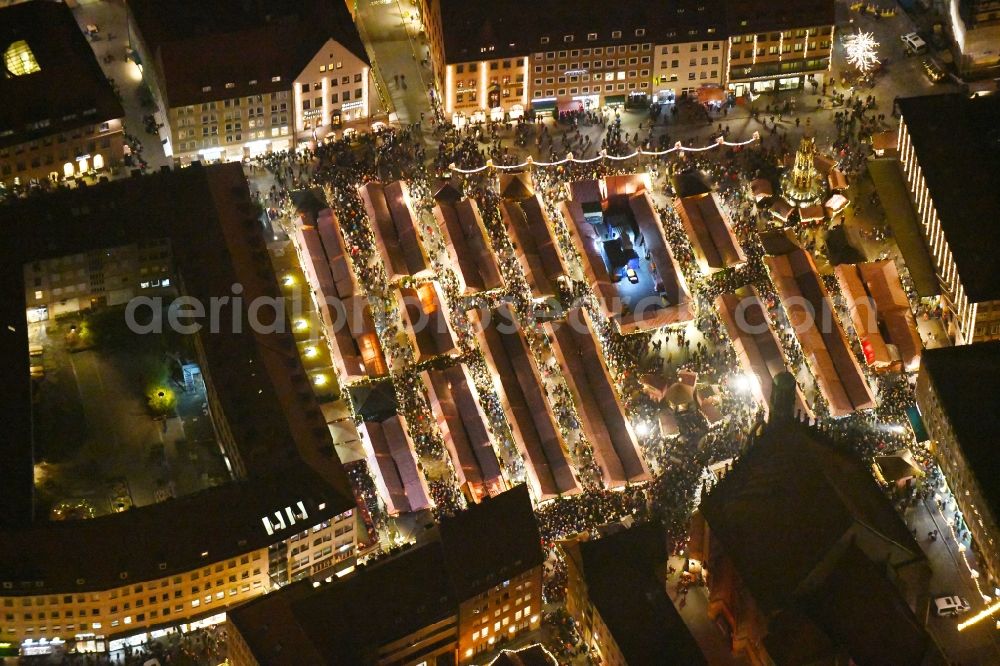 Nürnberg at night from above - Night lighting Christmassy market event grounds and sale huts and booths on Platz of Nuernberger Hauptmarkt in Nuremberg in the state Bavaria, Germany