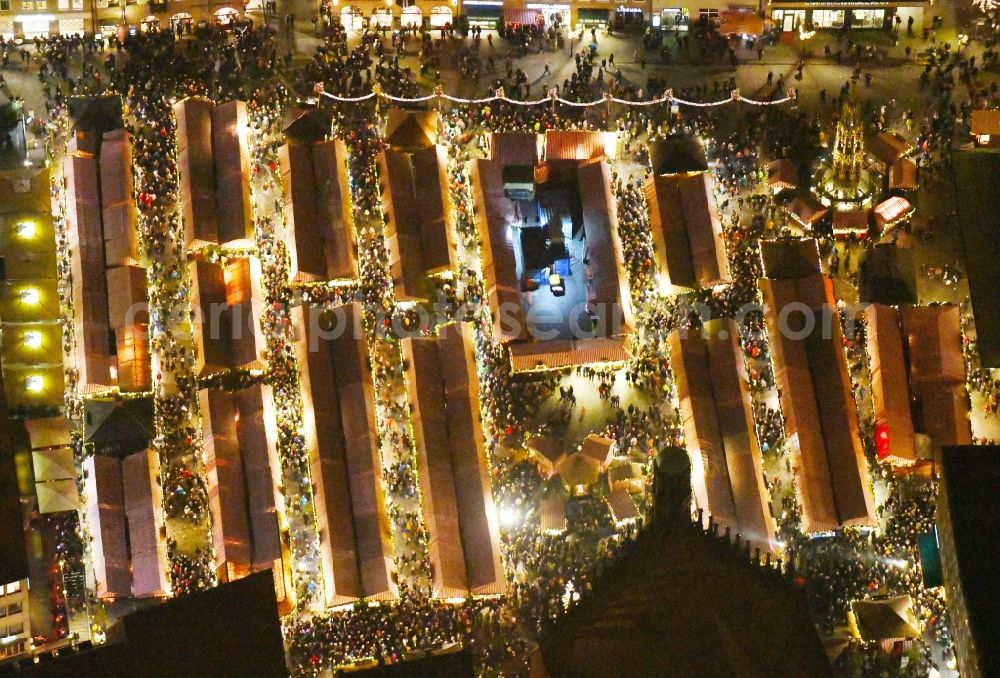 Aerial image at night Nürnberg - Night lighting Christmassy market event grounds and sale huts and booths on Platz of Nuernberger Hauptmarkt in Nuremberg in the state Bavaria, Germany