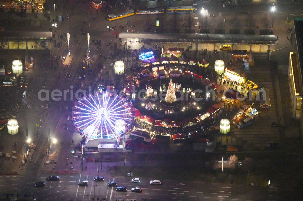 Aerial image at night Leipzig - Night lighting Christmassy market event grounds and sale huts and booths on Augustusplatz in Leipzig in the state Saxony, Germany