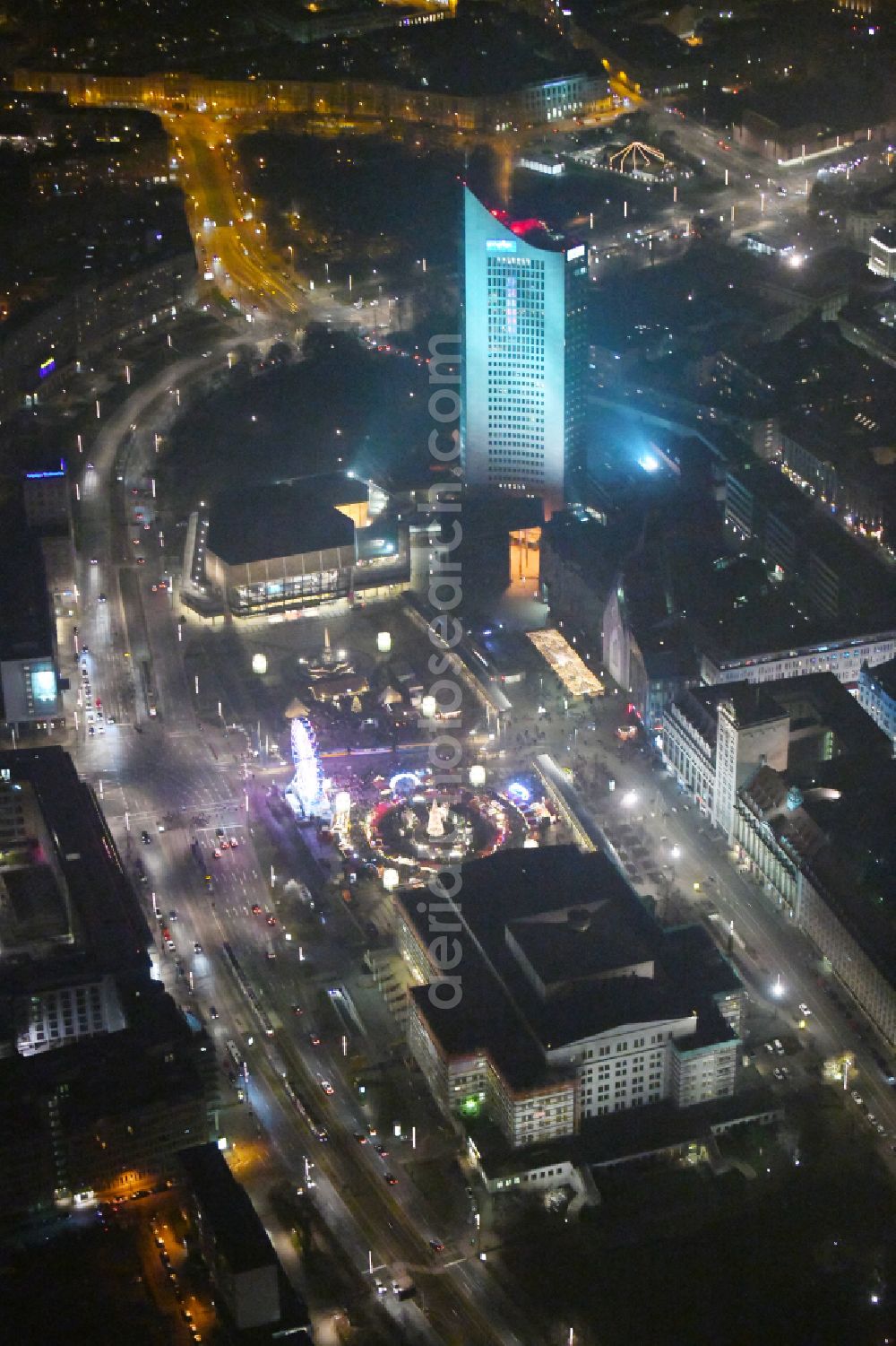 Leipzig at night from above - Night lighting Christmassy market event grounds and sale huts and booths on Augustusplatz in Leipzig in the state Saxony, Germany