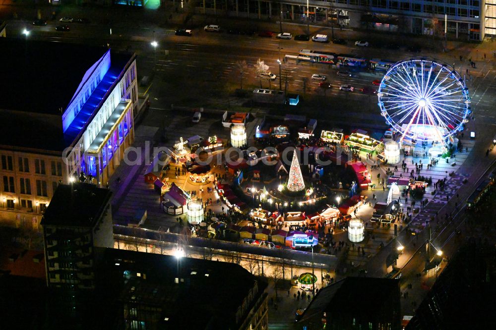 Leipzig at night from above - Night lighting Christmassy market event grounds and sale huts and booths on Augustusplatz in Leipzig in the state Saxony, Germany