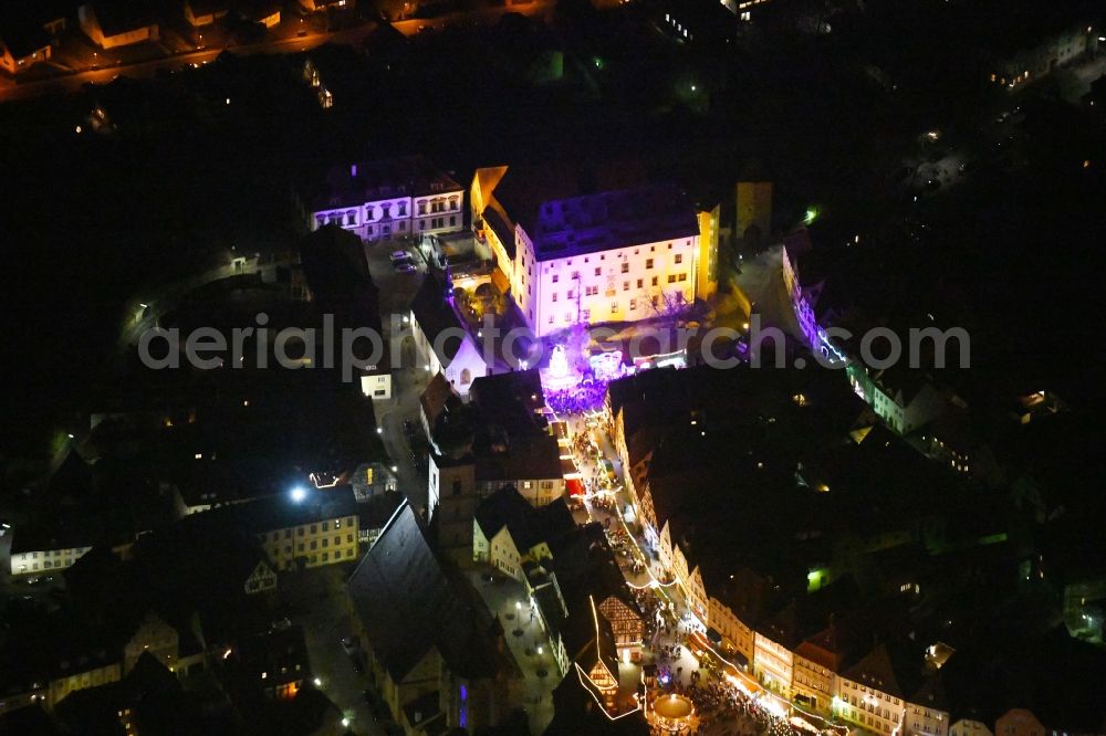 Aerial image at night Forchheim - Night lighting Christmassy market event grounds and sale huts and booths along the Hauptstrasse in Forchheim in the state Bavaria, Germany