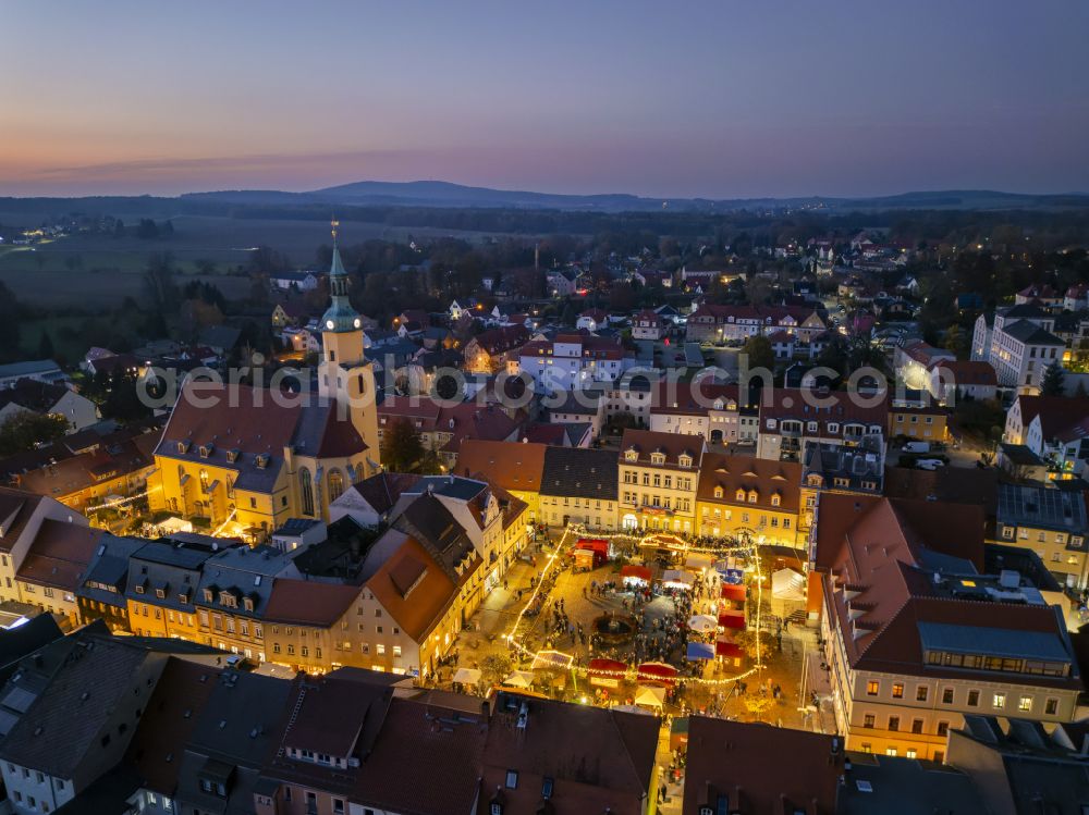 Pulsnitz at night from above - Night lighting christmassy market event grounds and sale huts and booths Pfefferkuchenmarkt on street Am Markt in Pulsnitz in the state Saxony, Germany