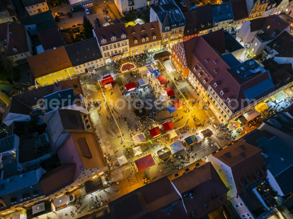 Pulsnitz at night from above - Night lighting christmassy market event grounds and sale huts and booths Pfefferkuchenmarkt on street Am Markt in Pulsnitz in the state Saxony, Germany