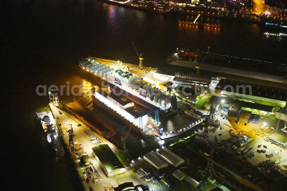 Hamburg at night from the bird perspective: Night lighting Shipyard - site of the Blohm + Voss in the district Kleiner Grasbrook in Hamburg