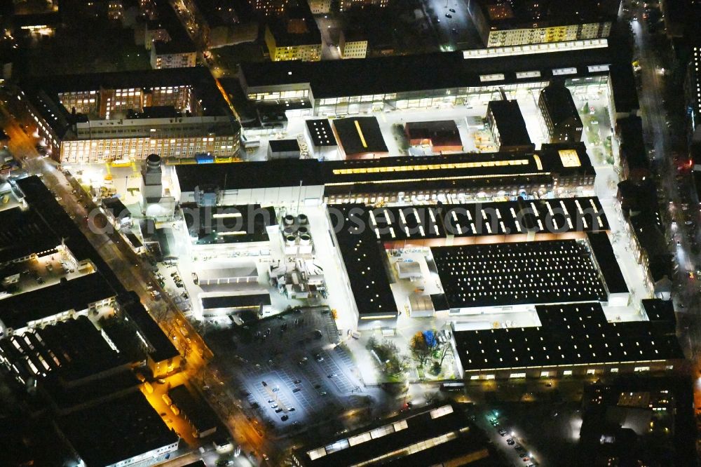 Aerial image at night Berlin - Night lighting Building and production halls on the premises of of Siemens AG Sector Energy on Huttenstrasse in the district Moabit in Berlin, Germany