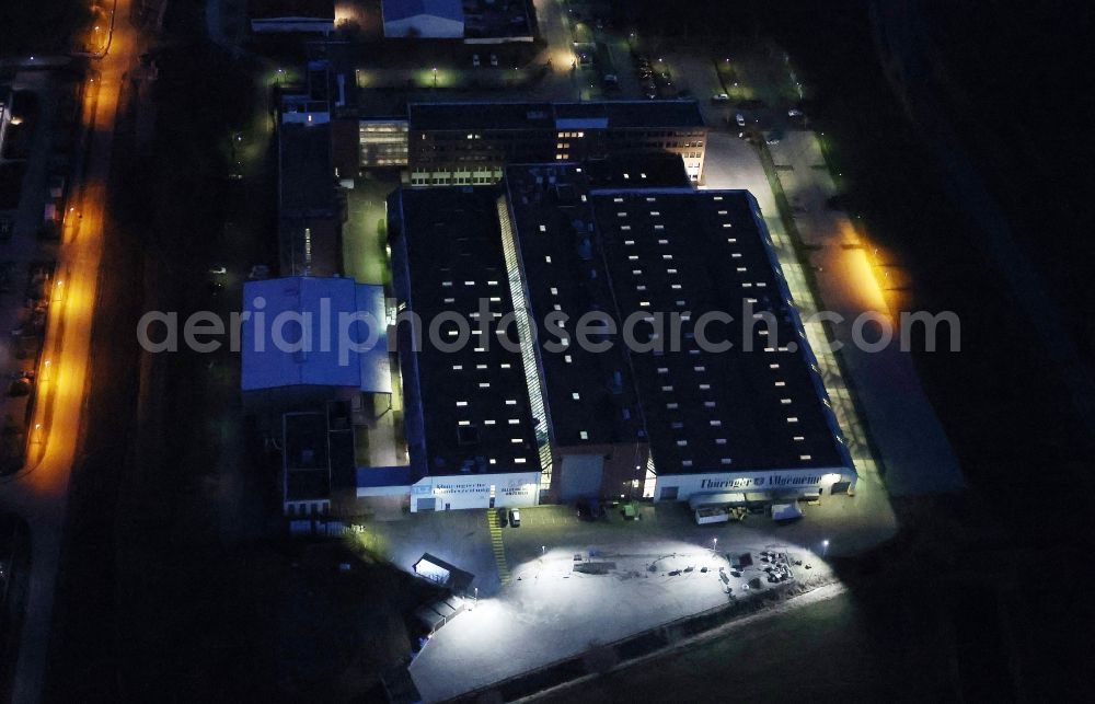 Aerial image at night Erfurt - Night lighting buildings and production halls on the factory premises of the offset printing Presse- and Medienhauses of Zeitungen Thueringer Allgemeine, Thueringische Landeszeitung and Allgemeiner Anzeiger on street Gottstedter Landstrasse in Erfurt in the state Thuringia, Germany