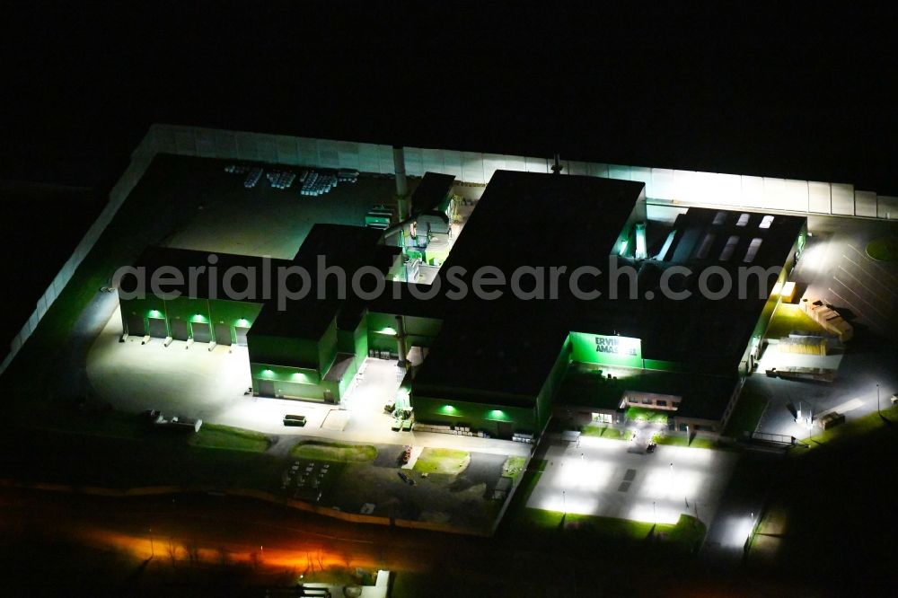 Glaubitz at night from above - Night lighting Building and production halls on the premises of Ervin Amasteel on Industriestrasse in Glaubitz in the state Saxony, Germany