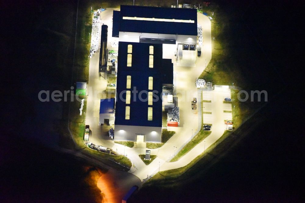 Schwerin at night from the bird perspective: Night lighting night view building and production halls on the premises of FVH Folienveredelung an der Ludwig-Boelkow-Strasse in Schwerin in the state Mecklenburg - Western Pomerania