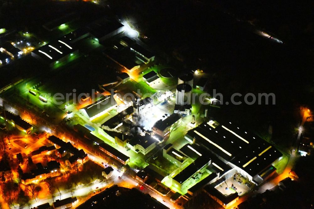 Aerial photograph at night Kyritz - Night lighting building and production halls on the premises of Kyritzer Staerke GmbH in Kyritz in the state Brandenburg, Germany