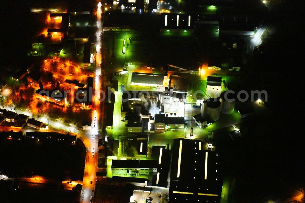 Aerial image at night Kyritz - Night lighting building and production halls on the premises of Kyritzer Staerke GmbH in Kyritz in the state Brandenburg, Germany