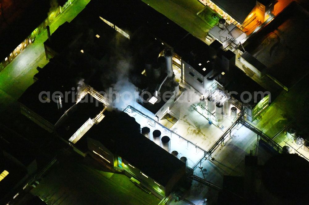 Aerial image at night Kyritz - Night lighting building and production halls on the premises of Kyritzer Staerke GmbH in Kyritz in the state Brandenburg, Germany