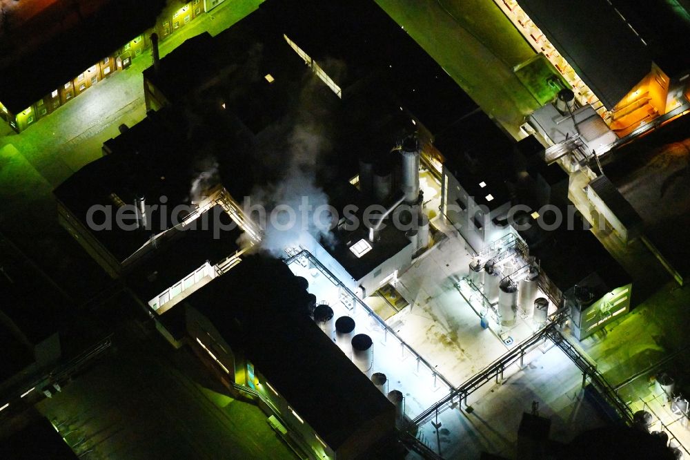 Kyritz at night from above - Night lighting building and production halls on the premises of Kyritzer Staerke GmbH in Kyritz in the state Brandenburg, Germany